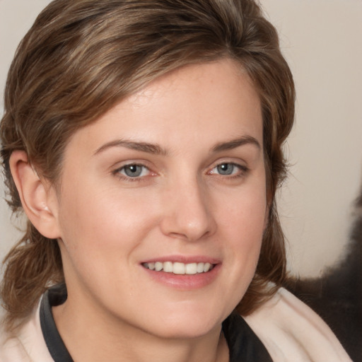 Joyful white young-adult female with medium  brown hair and grey eyes