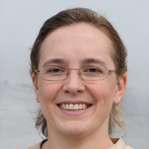 Joyful white adult female with medium  brown hair and blue eyes