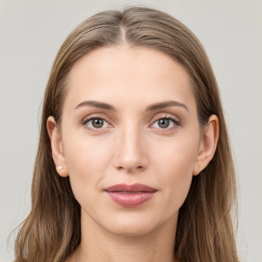 Joyful white young-adult female with long  brown hair and grey eyes