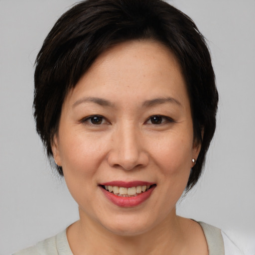 Joyful white adult female with medium  brown hair and brown eyes