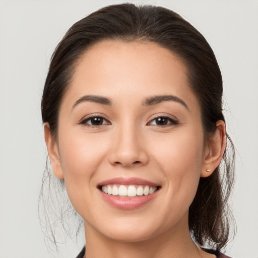 Joyful white young-adult female with long  brown hair and brown eyes