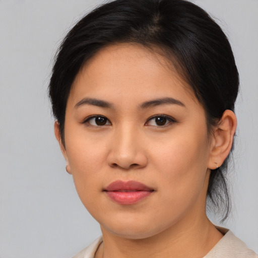 Joyful asian young-adult female with medium  brown hair and brown eyes