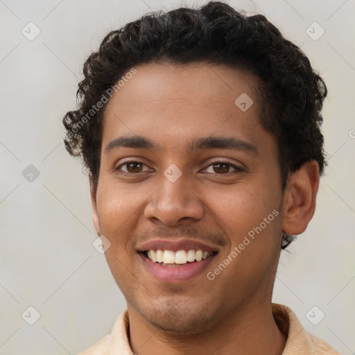 Joyful latino young-adult male with short  brown hair and brown eyes