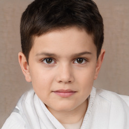 Joyful white child male with short  brown hair and brown eyes