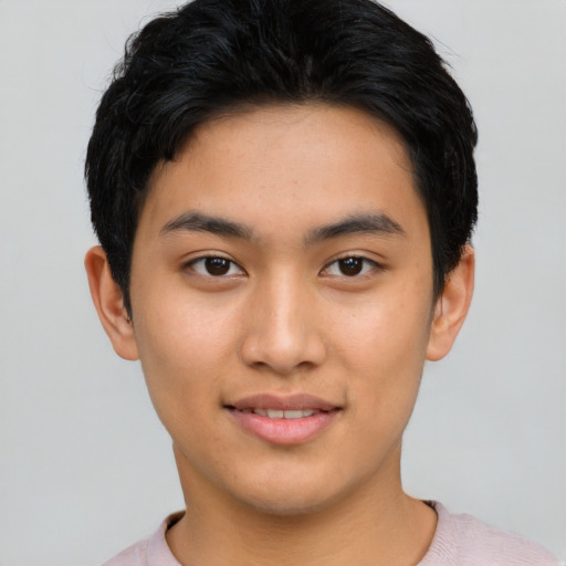 Joyful latino young-adult male with short  black hair and brown eyes
