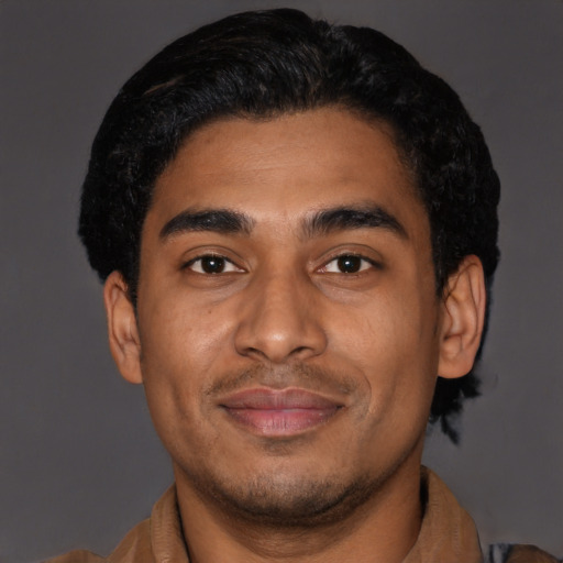 Joyful latino young-adult male with short  brown hair and brown eyes