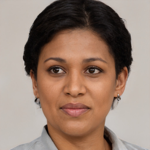 Joyful black adult female with short  brown hair and brown eyes