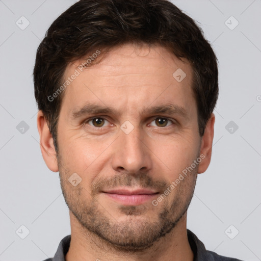 Joyful white adult male with short  brown hair and brown eyes