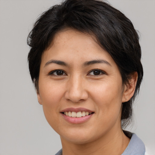 Joyful asian young-adult female with medium  brown hair and brown eyes