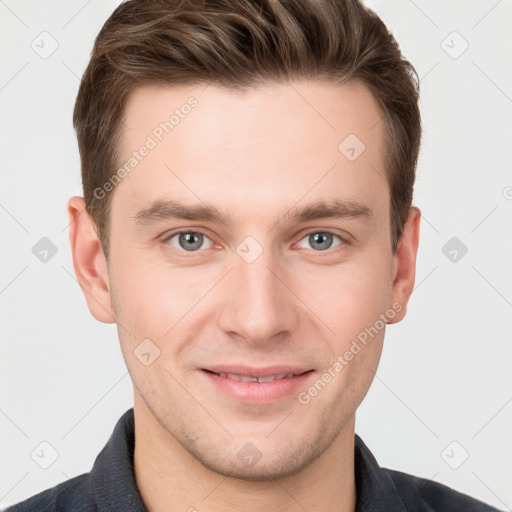 Joyful white young-adult male with short  brown hair and grey eyes