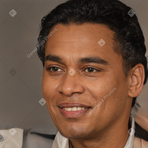 Joyful latino adult male with short  brown hair and brown eyes