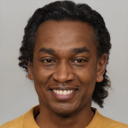 Joyful latino adult male with short  black hair and brown eyes