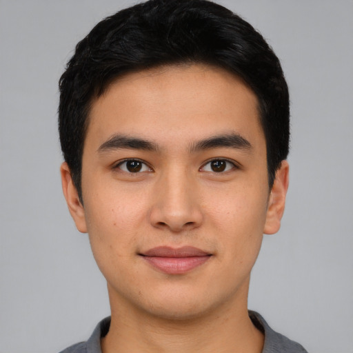 Joyful asian young-adult male with short  black hair and brown eyes