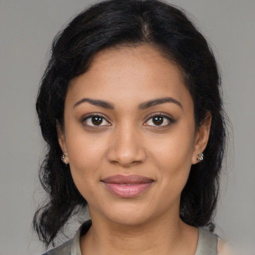 Joyful latino young-adult female with medium  brown hair and brown eyes