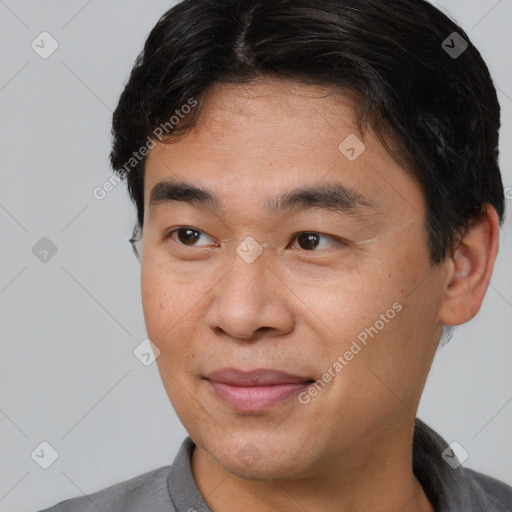 Joyful white adult male with short  brown hair and brown eyes