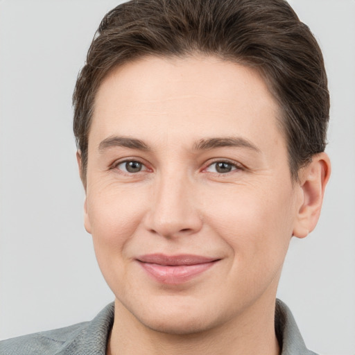 Joyful white young-adult female with short  brown hair and grey eyes