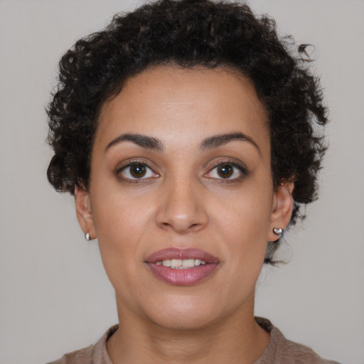 Joyful black young-adult female with short  brown hair and brown eyes