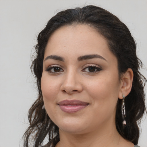 Joyful latino young-adult female with long  brown hair and brown eyes