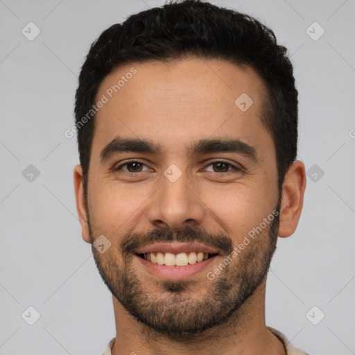 Joyful white young-adult male with short  black hair and brown eyes