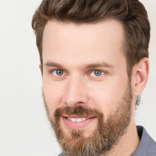 Joyful white adult male with short  brown hair and grey eyes