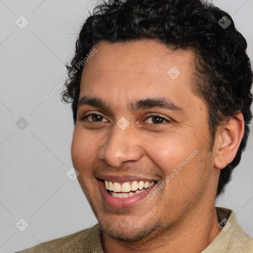 Joyful latino young-adult male with short  brown hair and brown eyes