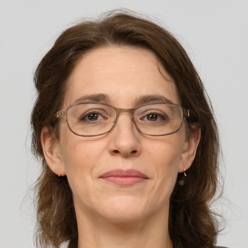 Joyful white adult female with medium  brown hair and grey eyes