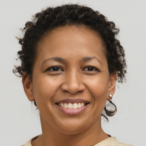 Joyful black adult female with short  brown hair and brown eyes