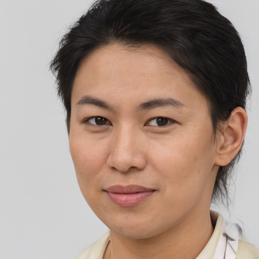 Joyful asian young-adult female with short  brown hair and brown eyes