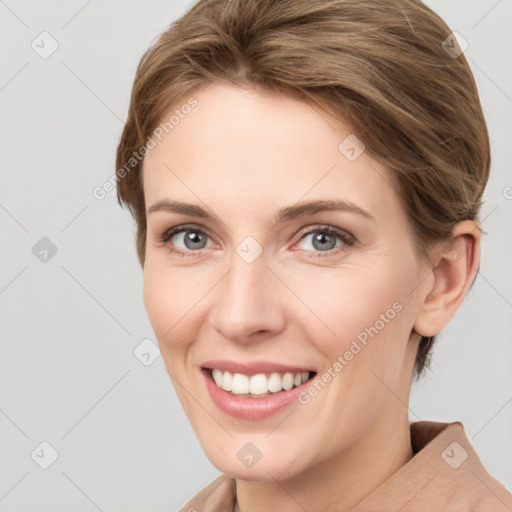 Joyful white young-adult female with short  brown hair and grey eyes