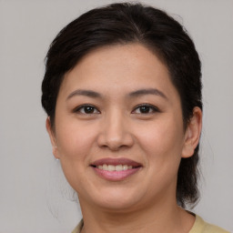 Joyful white young-adult female with medium  brown hair and brown eyes