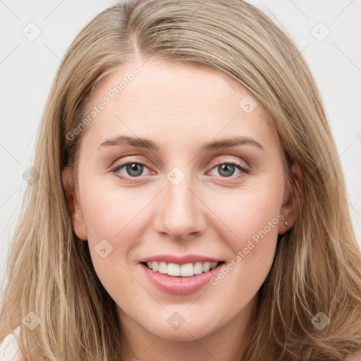 Joyful white young-adult female with long  brown hair and blue eyes