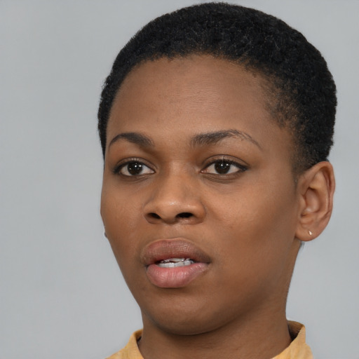 Joyful black young-adult female with short  black hair and brown eyes