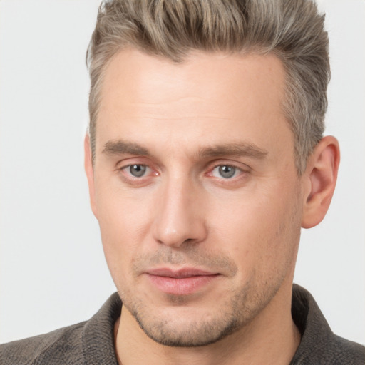 Joyful white adult male with short  brown hair and grey eyes