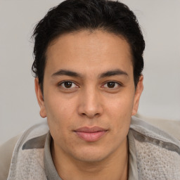 Joyful latino young-adult male with short  brown hair and brown eyes