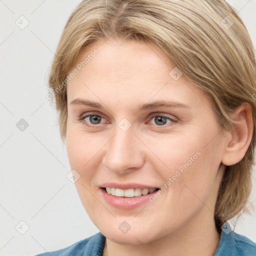 Joyful white young-adult female with medium  brown hair and blue eyes