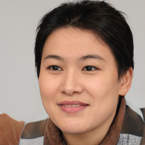 Joyful asian young-adult female with medium  brown hair and brown eyes