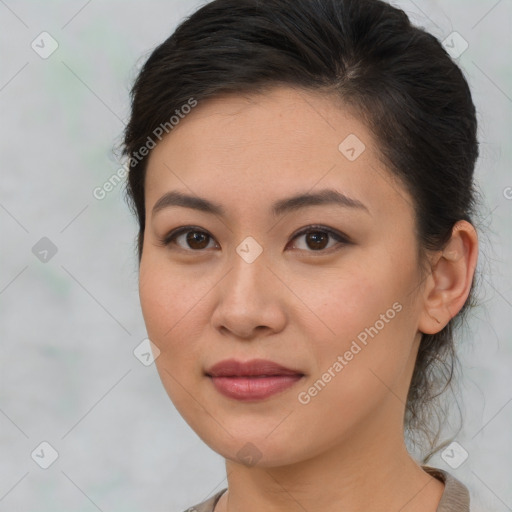 Joyful asian young-adult female with medium  brown hair and brown eyes