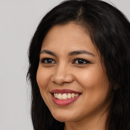 Joyful asian young-adult female with long  brown hair and brown eyes