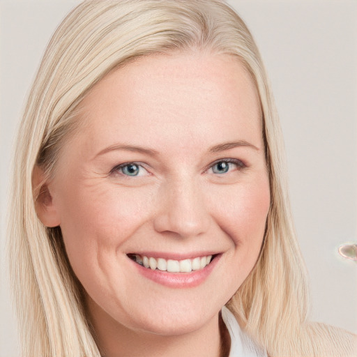 Joyful white young-adult female with long  blond hair and blue eyes