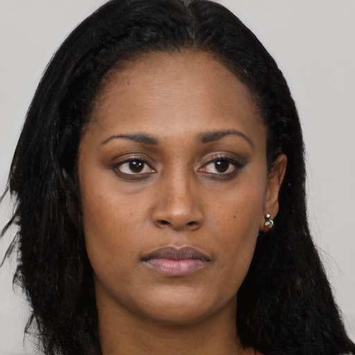 Neutral black young-adult female with long  brown hair and brown eyes
