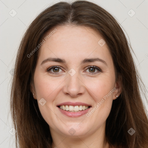 Joyful white adult female with long  brown hair and brown eyes