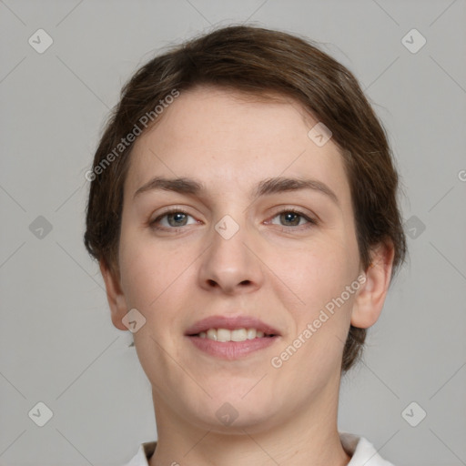 Joyful white young-adult female with short  brown hair and grey eyes