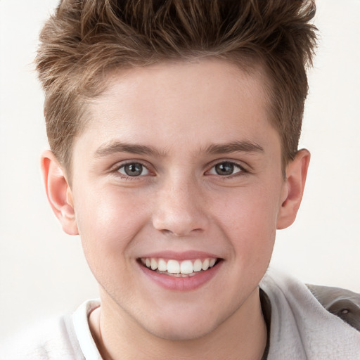 Joyful white child male with short  brown hair and grey eyes