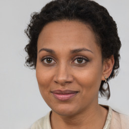 Joyful black adult female with short  brown hair and brown eyes