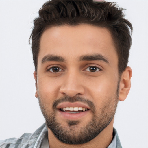 Joyful white young-adult male with short  black hair and brown eyes