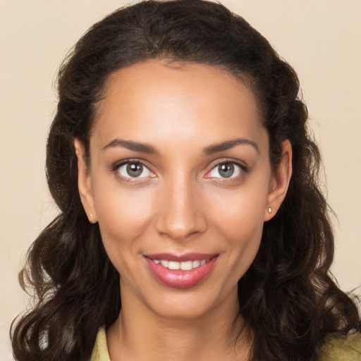 Joyful white young-adult female with long  brown hair and brown eyes