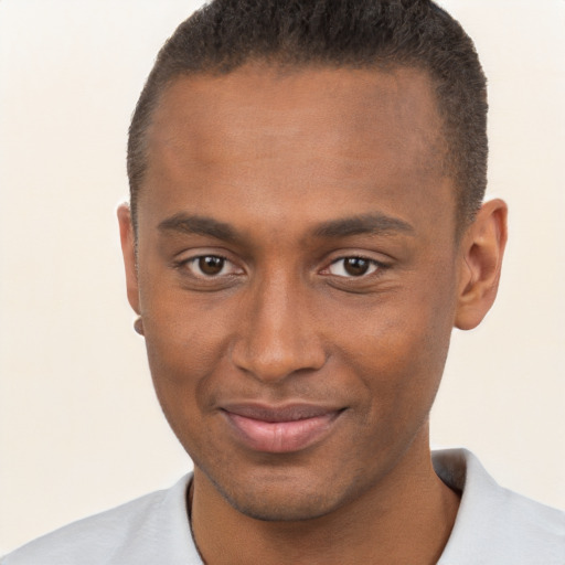 Joyful black young-adult male with short  brown hair and brown eyes