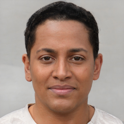 Joyful latino young-adult male with short  brown hair and brown eyes