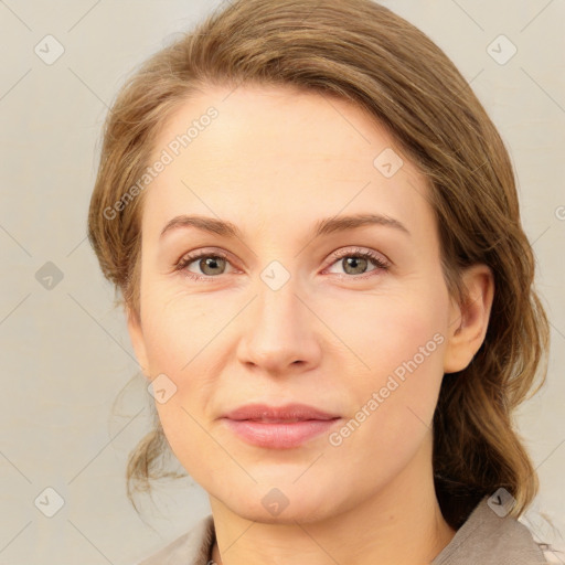 Joyful white young-adult female with medium  brown hair and green eyes