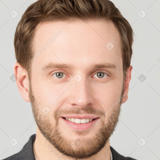 Joyful white young-adult male with short  brown hair and grey eyes